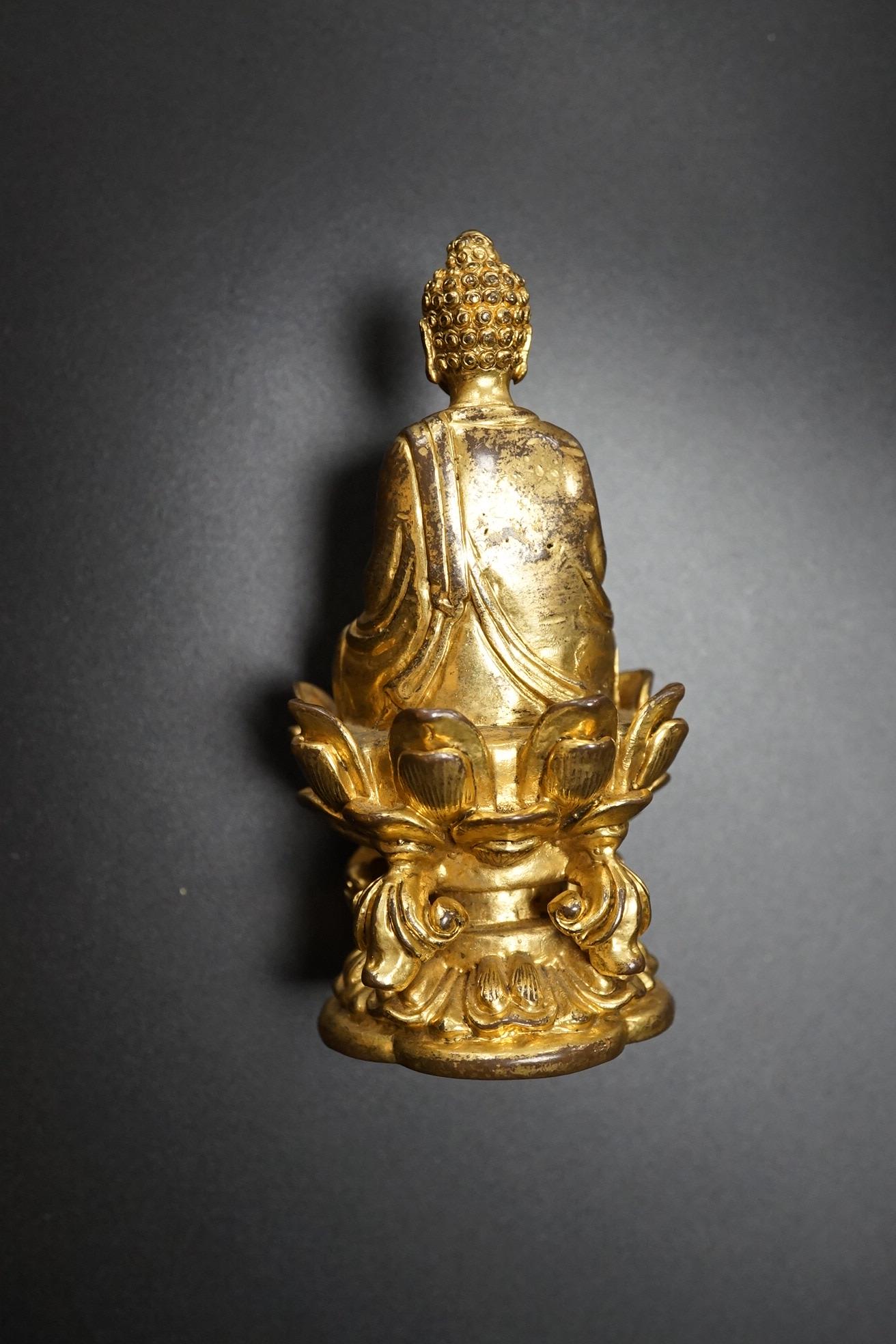 A Chinese miniature gilt metal figure of seated Buddha, 8cm high
